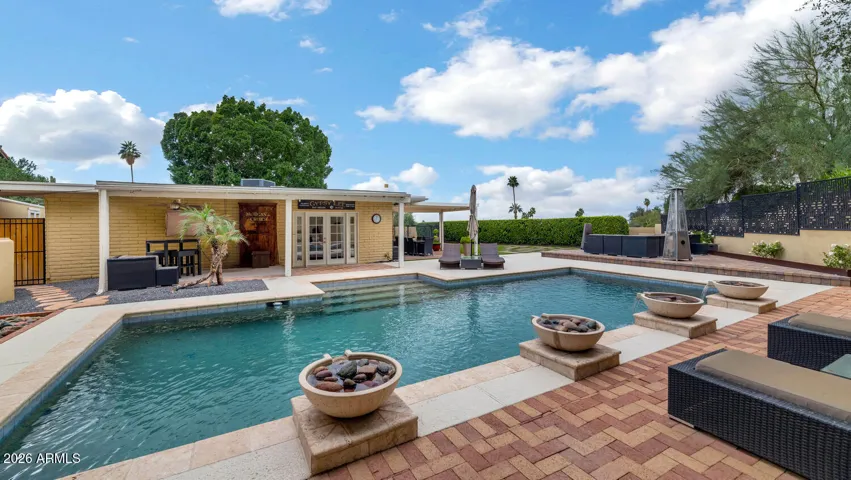 This smart-enabled oasis features seamless indoor-outdoor living and a resort-style backyard with custom Paddock pool, elegant fountains, and five distinct patios perfect for entertaining under the stars.