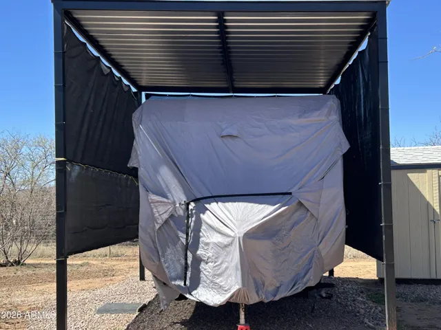 RV shelter with metal roof and sunscreen awnings