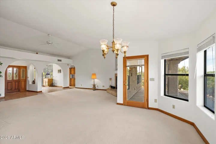 Access to patios from den, kitchen, living room/dining, primary bedroom.
