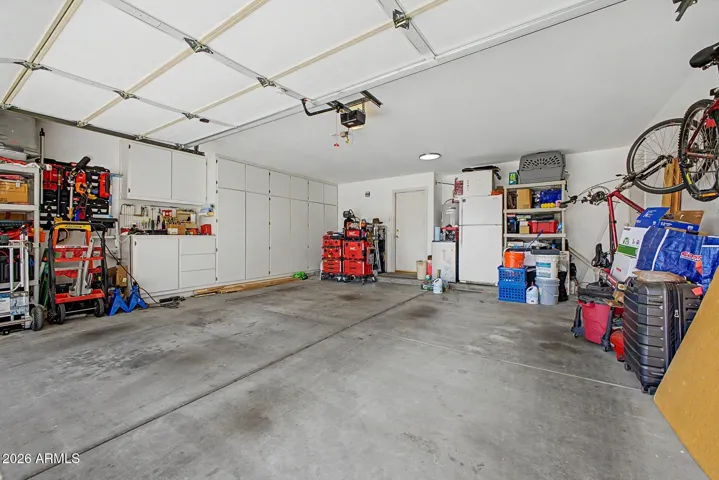 Large 2 car Garage. Storage cabinets on one side.