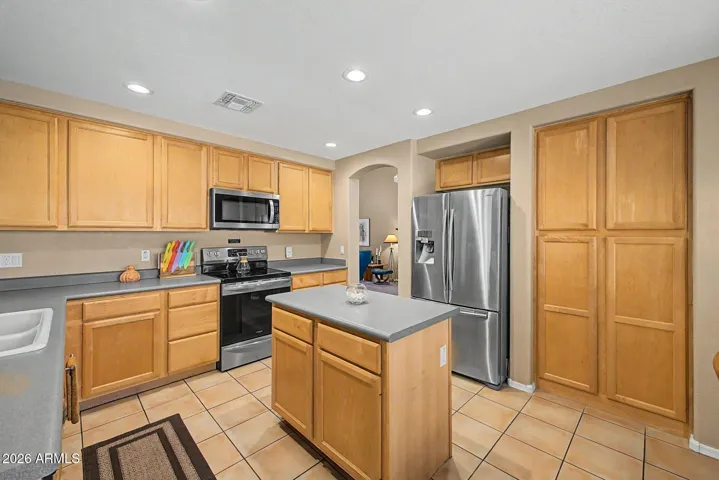 Spacious Kitchen Layout with Island and Pantry Cabinets