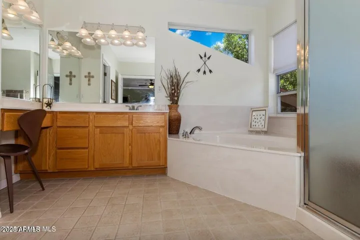 Bathroom with soaking tub and walk in shower, vanity.