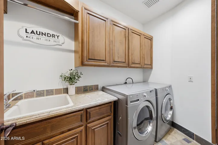 With built-in cabinetry and utility sink