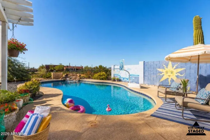 This photo has been virtually staged to add light staging to the backyard.