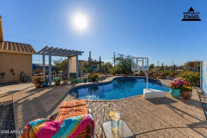 This photo has been virtually staged to add light staging to the backyard.