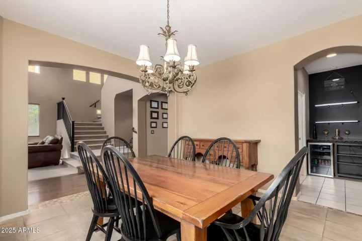 Digitally edited to remove taxidermy. Front formal dining room and living room. Pass through to wine bar and kitchen.