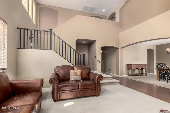 Digitally edited to remove taxidermy. Front living room and formal dining room.
