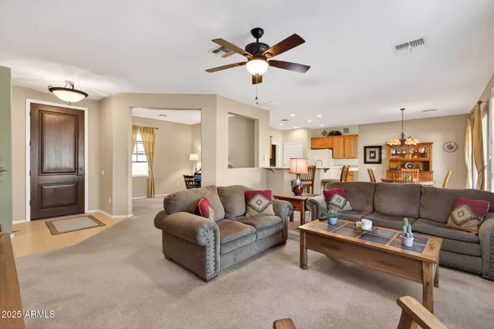 The open floor plan offers an airy flow between the Great Room, Dining, Kitchen & Den.