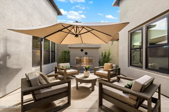 Inviting private courtyard with gas fireplace and stylish seating areas. This Scottsdale outdoor space is perfect for relaxing evenings and intimate gatherings year-round.