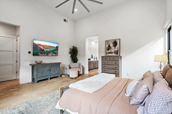 Spacious primary suite featuring vaulted ceilings, modern finishes, and a calming atmosphere. Designed for relaxation and luxury living in Scottsdale.