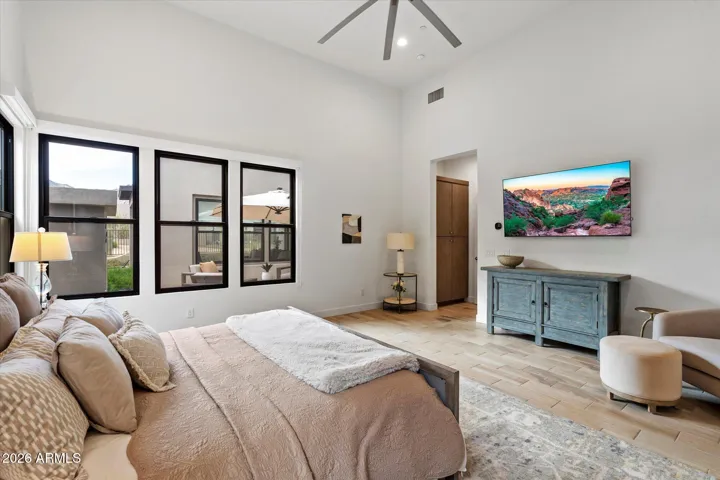 Elegant primary bedroom with large windows, soft finishes, and generous space. A peaceful retreat offering comfort and privacy in this Scottsdale luxury home.