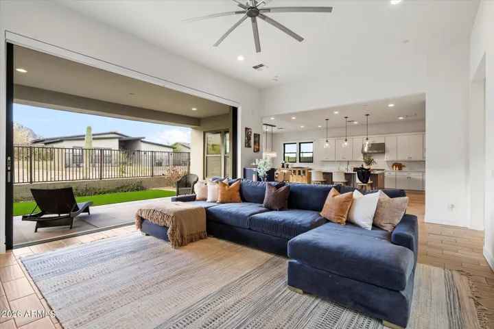 Light-filled open- concept living space with soaring ceilings, oversized windows, and seamless indoor-outdoor flow. This Scottsdale Luxury home features modern finishes and expansive entertaining areas ideal for everyday living and hosting