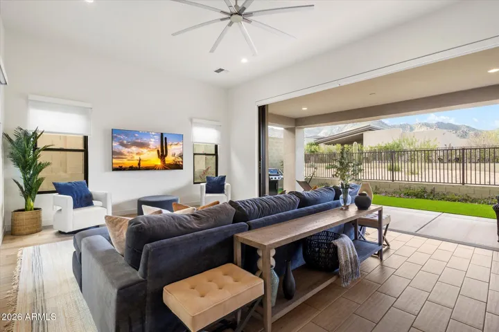 Stunning living area with a wide stackable glass door opening to the covered patio. This Scottsdale home emphasizes indoor-outdoor living, ideal for entertaining and enjoying Arizona’s lifestyle
