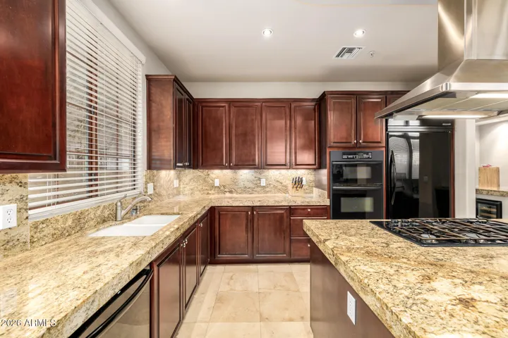 Sleek granite countertops & a spacious walk-in pantry.