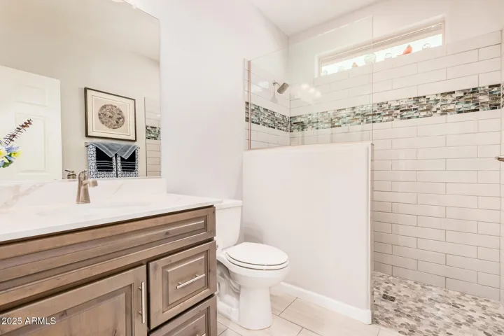 Guest Bathroom with Custom Tiled Pony Wall & Glass Walk-In