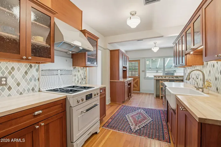 Remodeled kitchen with cherry wood cabinets and gas stove