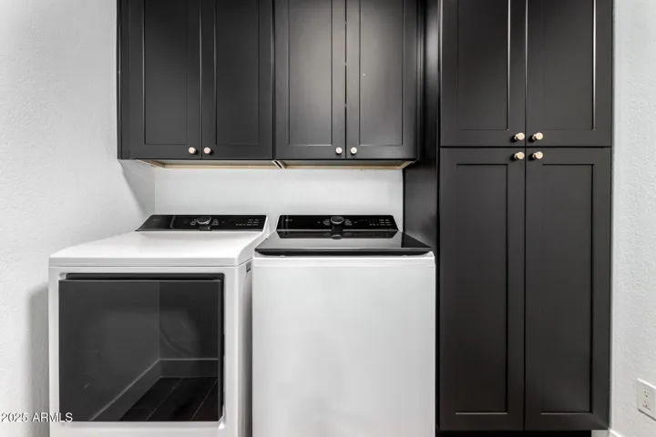 LAUNDRY ROOM WITH STORAGE AND WASHER AND DRYER