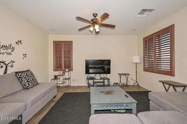 Spacious formal living room, dining room & family room w/ plantation shutters T/O!