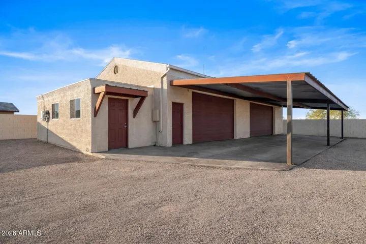 Detached shop with covered exterior area, multiple access points, and flexible layout. Ideal for storage, business use, or workshop needs.