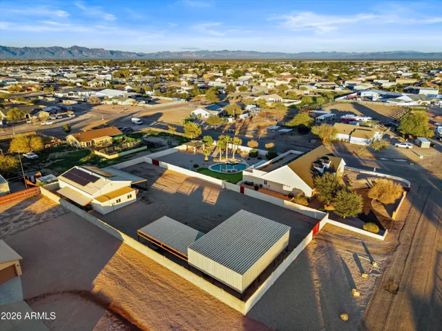 Another angle of the complete property illustrating fenced boundaries, multiple structures, and generous spacing throughout. A clear view of how thoughtfully the property is designed for flexibility and function.