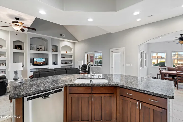 The large center island anchors the kitchen and opens directly to the living room. This setup allows for casual seating, food prep, and conversation while maintaining sightlines to the main living space.
