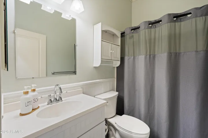 The second bathroom includes a soaking tub, updated vanity, and clean finishes. Conveniently positioned near the secondary bedrooms, this bath serves both guests and household members with ease.