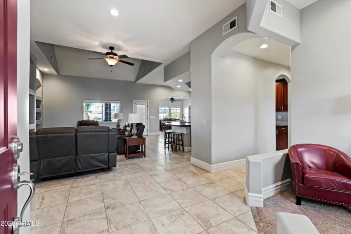 The front entrance opens into a bright, open layout with immediate sightlines to the great room. Tile flooring continues throughout the main living areas, creating a cohesive and low-maintenance design.