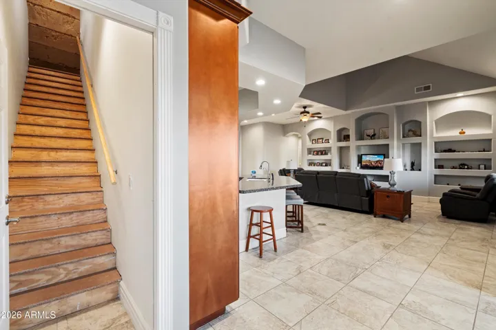 Convenient interior staircase leading to the insulated and climate-controlled upper-level storage area.
