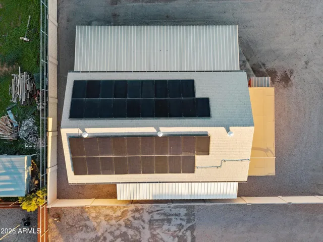 Aerial capturing both sides of the solar panels on the detached shop. Solar system is paid in full, adding long-term value and efficiency to the property’s functional spaces.