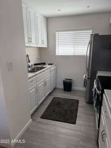 Opened up kitchen added new cabinets, countertops, dishwasher, refrigerator, b/i microwave, counter & cabinet for desk.