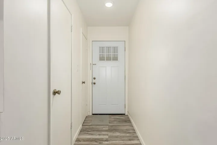 Front hallway view of front door, has hotwater heater closet, and coat/storage closet too!