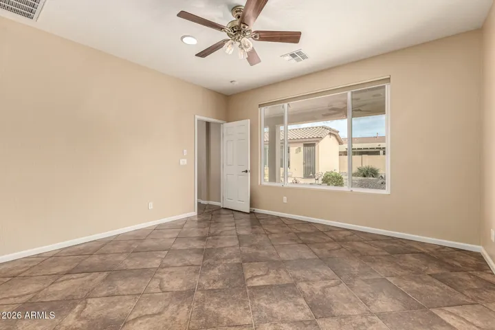 This spacious room overlooks the beautiful back yard and fountain area. It's has a full covered patio over the window too.