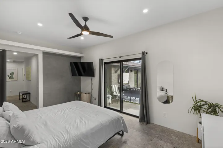 Primary bedroom with slider access to backyard