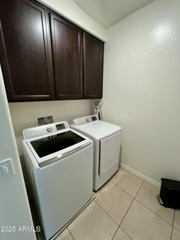 Upstairs laundry room with washer and dryer provided.