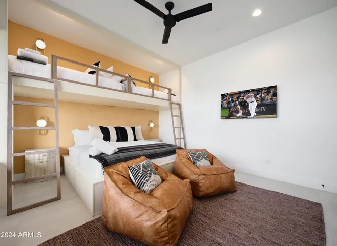 5th Bedroom featuring 2 Twin beds over a King bed with a Smart TV, closet space, and bedroom furnishings.