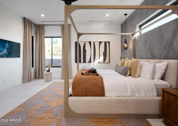 Primary Bedroom featuring a King bed with backyard access, a Smart TV and an en-suite Primary bathroom.