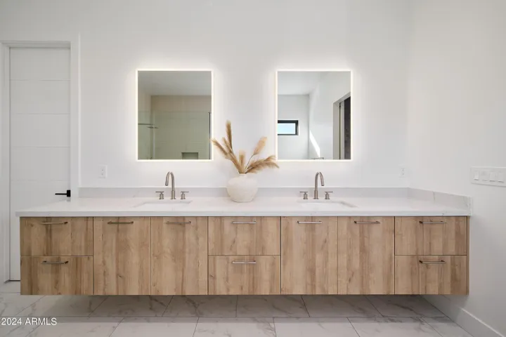 Luxurious Primary Bathroom (Primary Bedroom en-suite) featuring a dual vanity with a soaking tub and a stand-in shower.
