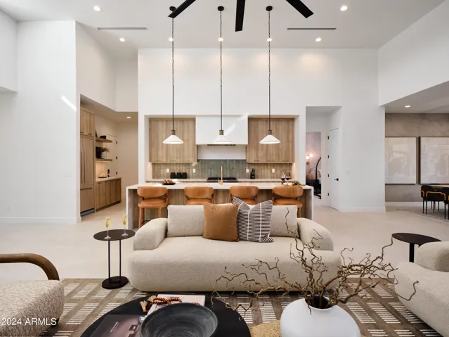 Grand open-concept living space with designer decor, featuring a fireplace and Smart TV.