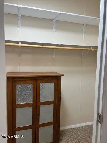 Walk-in closet in primary bedroom