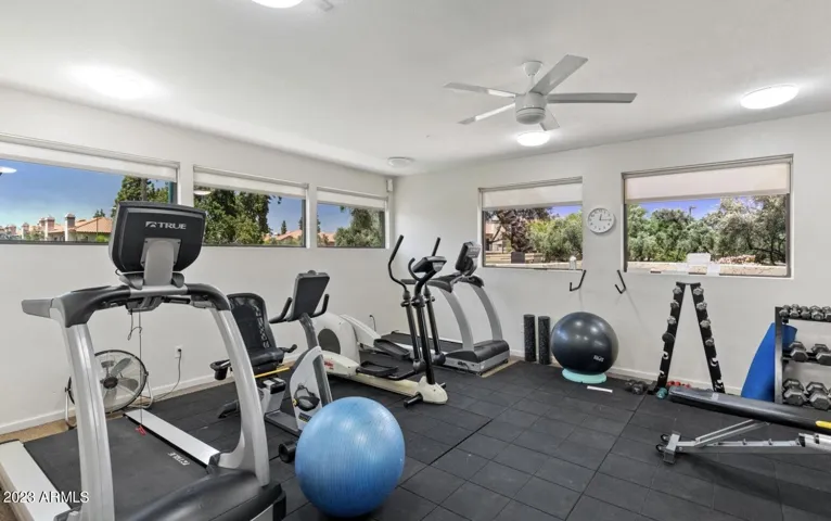 On-site fitness center featuring cardio machines, strength equipment, and natural light. Residents enjoy convenient wellness amenities within this Scottsdale gated community with pool and clubhouse access.