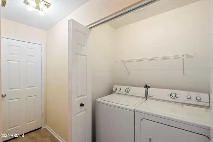 Convenient in-unit washer and dryer with overhead storage shelving for added organization. This Scottsdale condo offers low-maintenance living with practical features and everyday functionality.