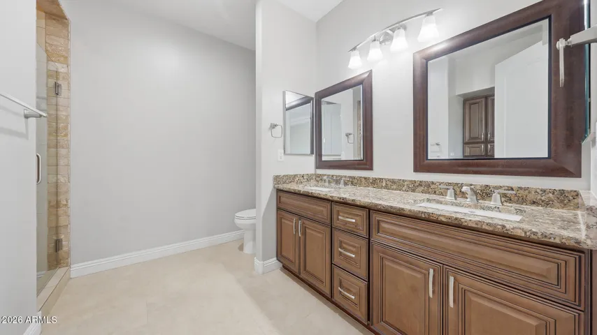 Main bath has double sinks, granite counters and large linen/storage closet