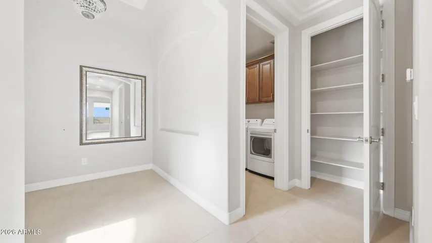 Large storage closet near laundry room with new washer and dryer