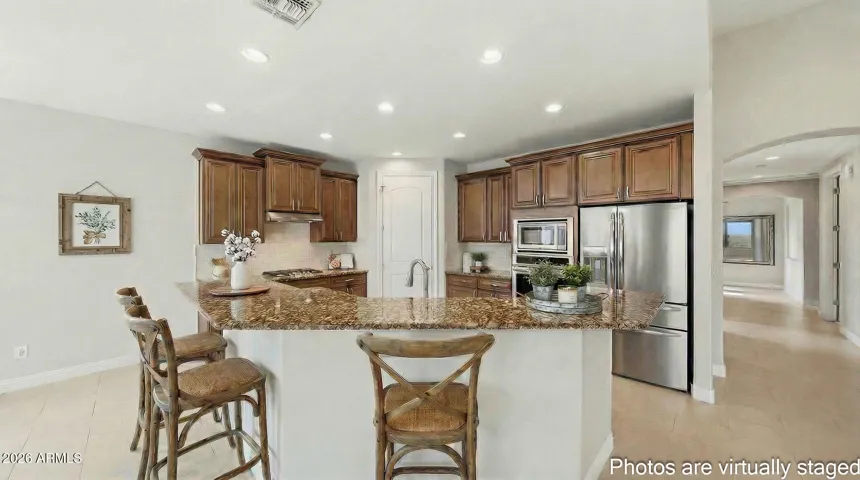 Gourmet cook's kitchen, gas cooktop, walk in pantry, wall range, staggered cabinetry and crown molding compliments the beautiful cabinetry and granite