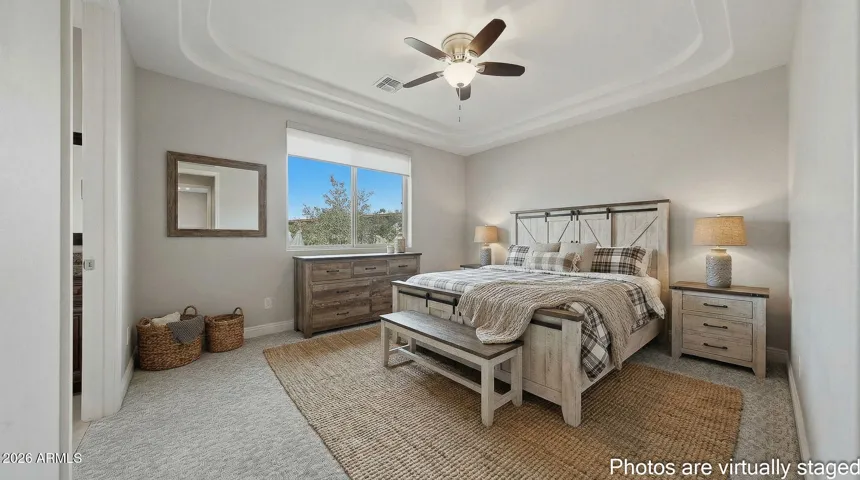 Main bedroom is large with custom ceiling treatments