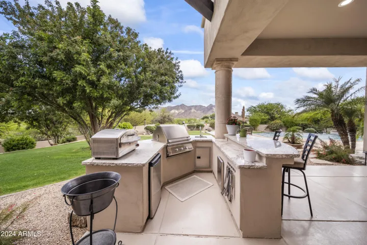 Outdoor Bar Area with Stunning Granite Countertops. Built in BBQ, Sink & Fridge