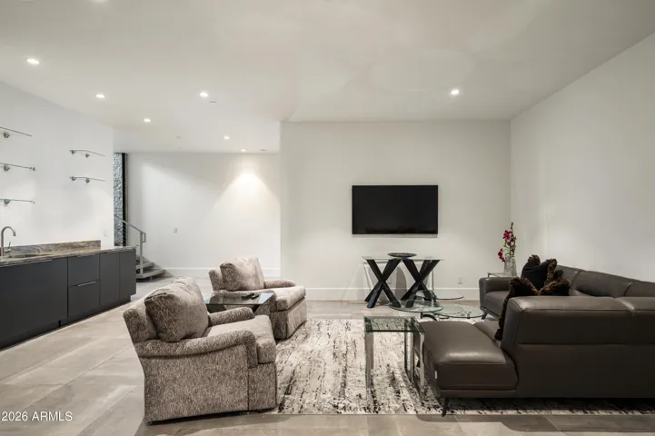 The lower level boasts a wet bar, spacious living area, and two en suite bedrooms, each with generous walk-in closets.