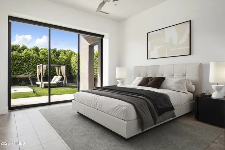 The primary bedroom is the sole suite on the main level, offering a serene and private retreat thoughtfully separated from guest accommodations and other living spaces.