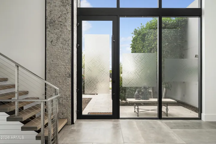 Beautiful foyer designed to flood the space with natural light while preserving privacy through elegant textured glass.