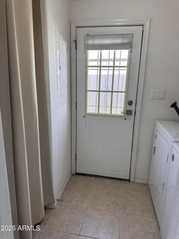 Extra storage closet off the laundry room and door to the backyard